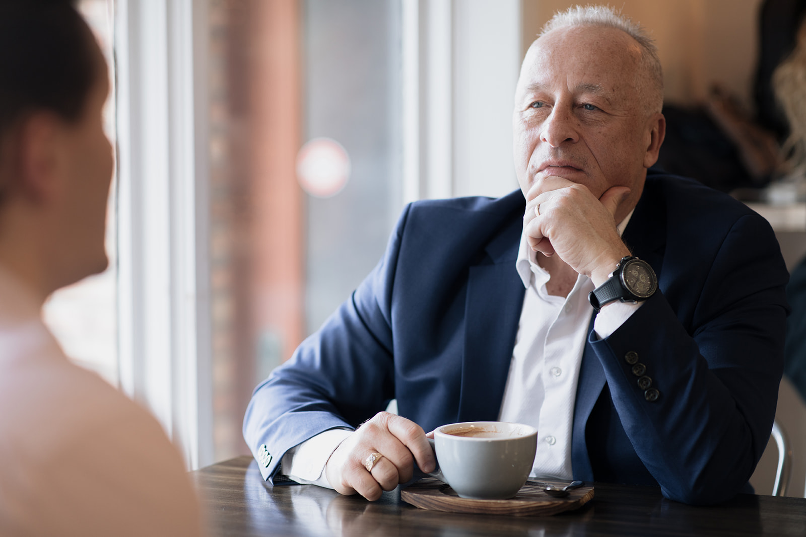 Dr. Jeff Williamson listening intently over coffee